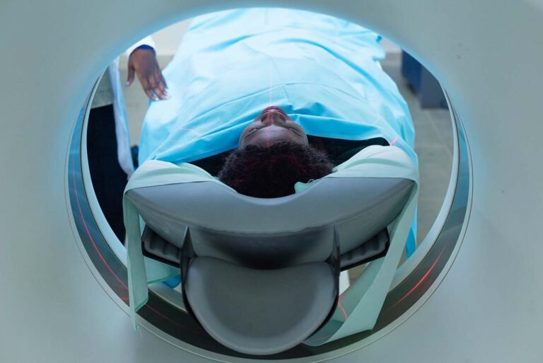 A-female-patient-lays-inside-a-CT-scan-in-a-hospital-photographer-in-kenya