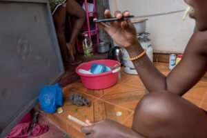 A-lesbian-couple-cook-a-meal-together-at-their-home-in-kampalaUganda