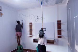 A-lesbian-couple-paint-their-new-home-together-in-Makindye-after-shifting-to-flee-from-segregation-in-their-previous-household