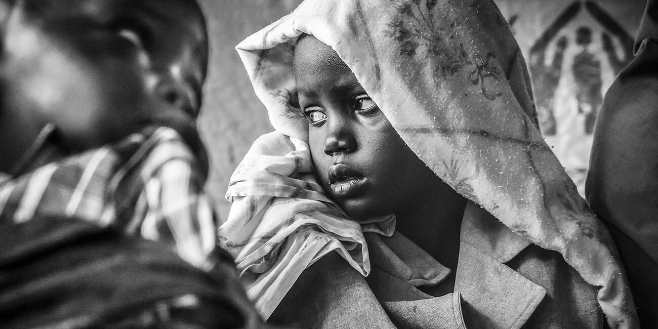 A-sick-girl-waitmedicakl-attention-in-a-health-centre-in-bidibidi-refugee-campUganda-East-africa