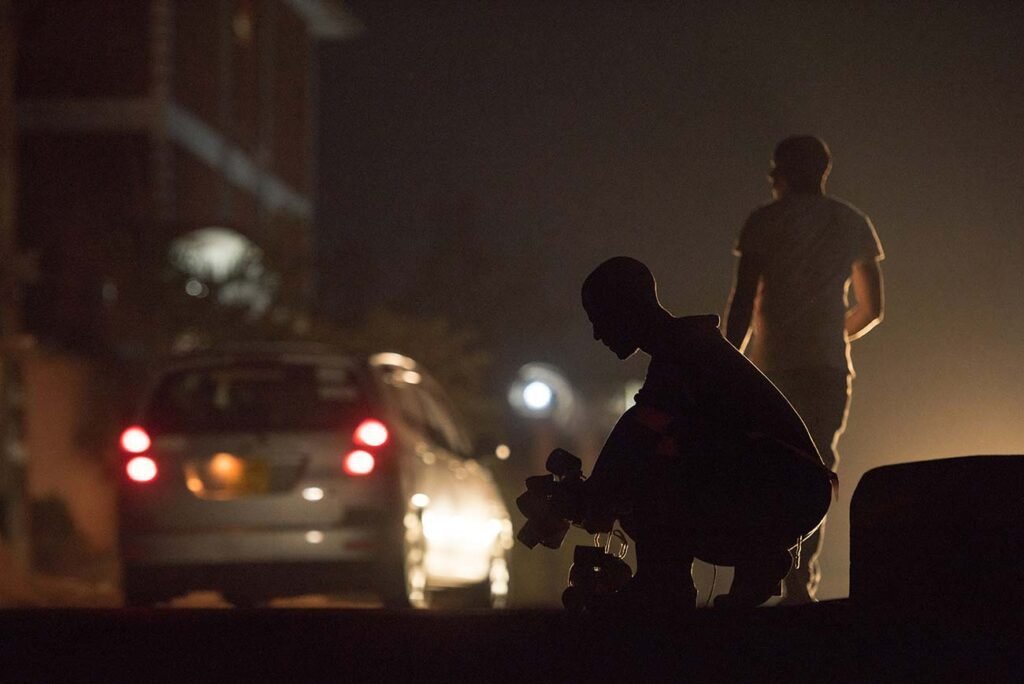 A-silhoute-of-rober-selling-lamps-made-by-recycling-by-the-roadside-in-kampala-uganda-1
