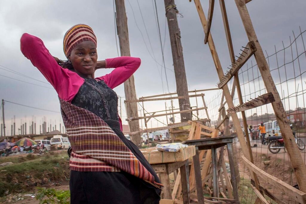 A-street-vendor-Annet-frowns-in-agitation-while-a-storm-approaches-in-kalerweUganda