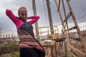 A-street-vendor-Annet-frowns-in-agitation-while-a-storm-approaches-in-kalerweUganda