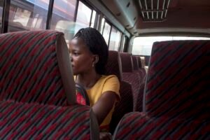Annet-a-hawker-sits-o-a-bus-to-go-visit-her-children-in-jinjaUganda