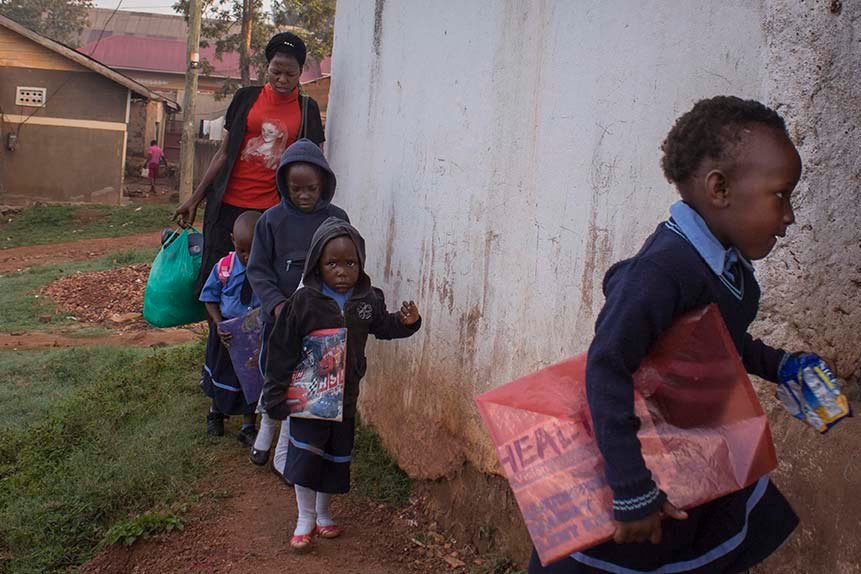 Annet-arrives-at-school-in-the-mornign-with-some-children-whom-she-escorts-to-school-from-the-neighbourhood-in-KampalaUganda