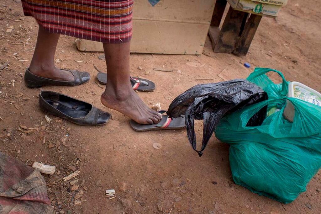 The-switch-Annet-changes-her-shoes-as-she-changes-proffesions-to-street-vending-in-kalerweUganda