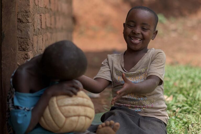 Two-young-sisters-play-together-in-rakaiuganda-with-a-volley-ball-photographer-in-kenya